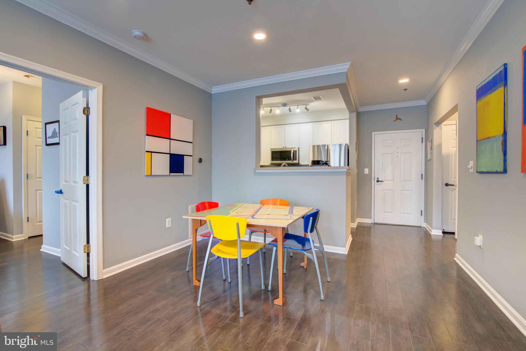 1855 Stratford Park Place, Unit 310 Reston, VA 20190 - Photo 7 of 62 a view of a dining room with furniture and wooden floor