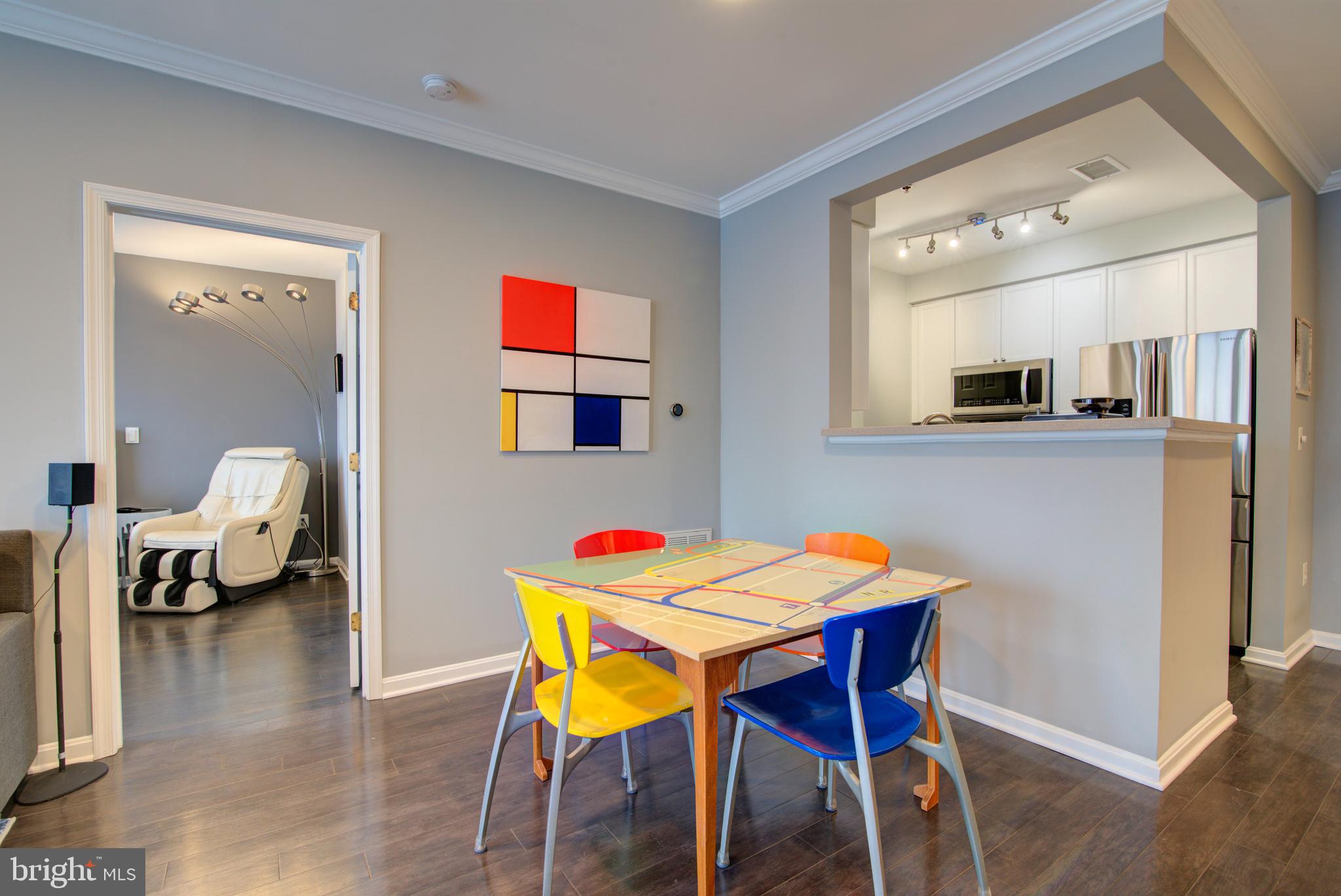 1855 Stratford Park Place, Unit 310 Reston, VA 20190 - Photo 8 of 62 a dining room with a wooden table and chairs