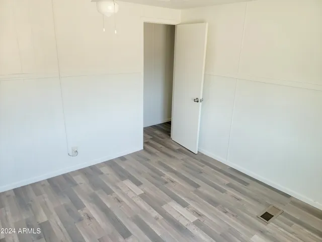 an empty room with wooden floor