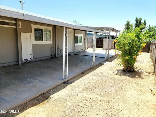 a view of house with backyard and glass windows