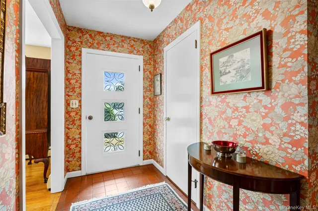 a living room with furniture and large windows