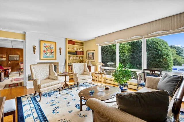 a living room with furniture and a floor to ceiling window
