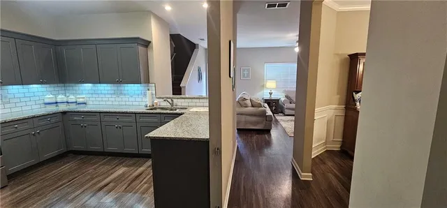 a kitchen with sink and cabinets