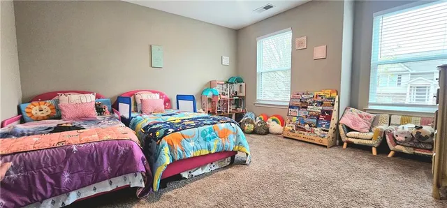 a bedroom with two beds and a window