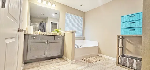 a spacious bathroom with a granite countertop sink a mirror and a