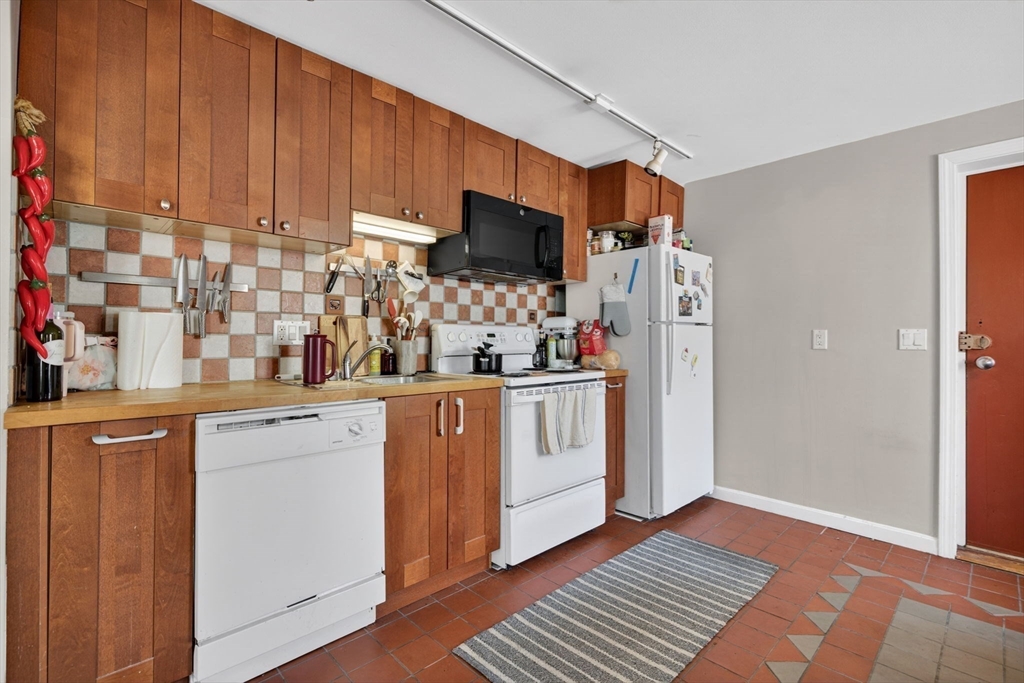 1800 Columbia Road, Unit 6 Boston, MA 02127 - Photo 3 of 11 a kitchen with white cabinets and white appliances