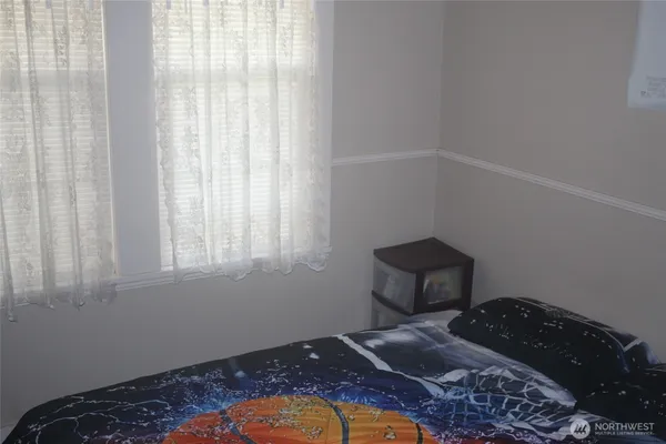 a bedroom with a bed and flat screen tv