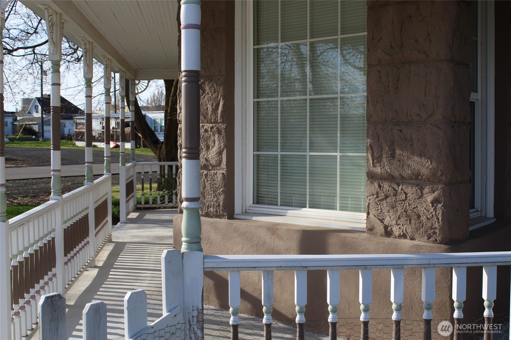 209 East Alder Avenue Ritzville, WA 99169 - Photo 5 of 15 a porch with a bench next to a yard