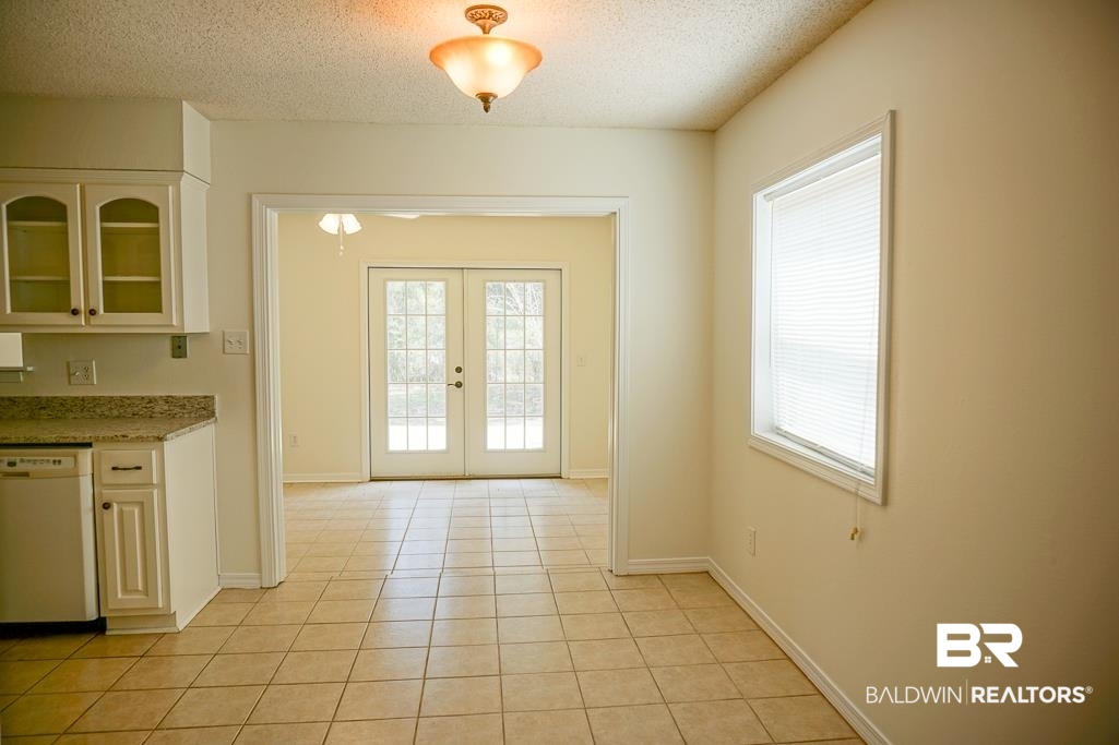 4377 Fathbrook Lane Mobile, AL 36693 - Photo 6 of 19 Entryway featuring french doors, light tile patterned flooring, baseboards, and a textured ceiling