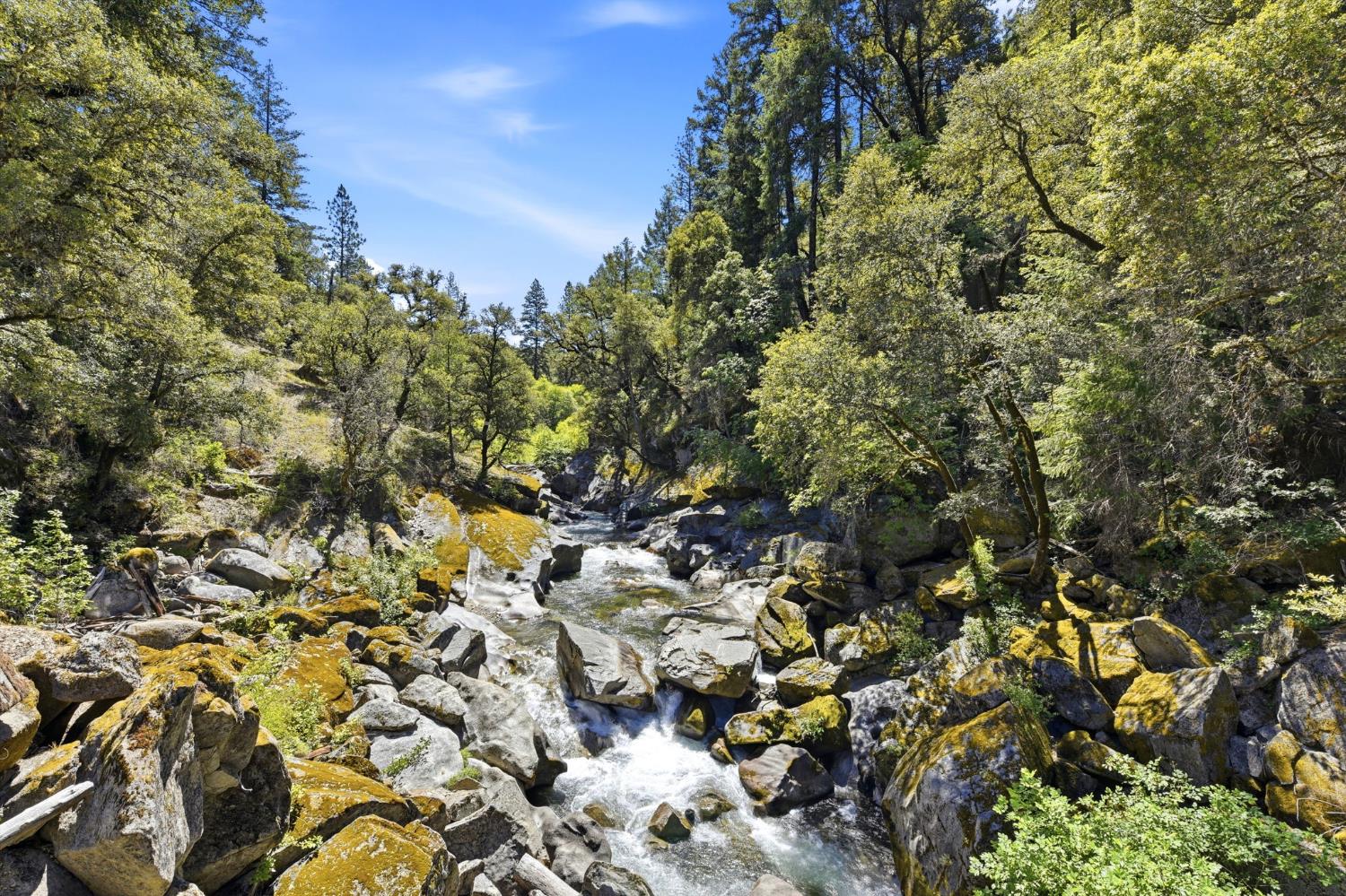 7201 Happy Valley Road Somerset, CA 95684 - Photo 70 of 75 The natural landscape featuring the flowing Middle fork of the Cosumnes River meanders along Happy Valley Road, and is surrounded by large, moss-covered boulders and dense, mature trees. Such a magical drive and place to experience.