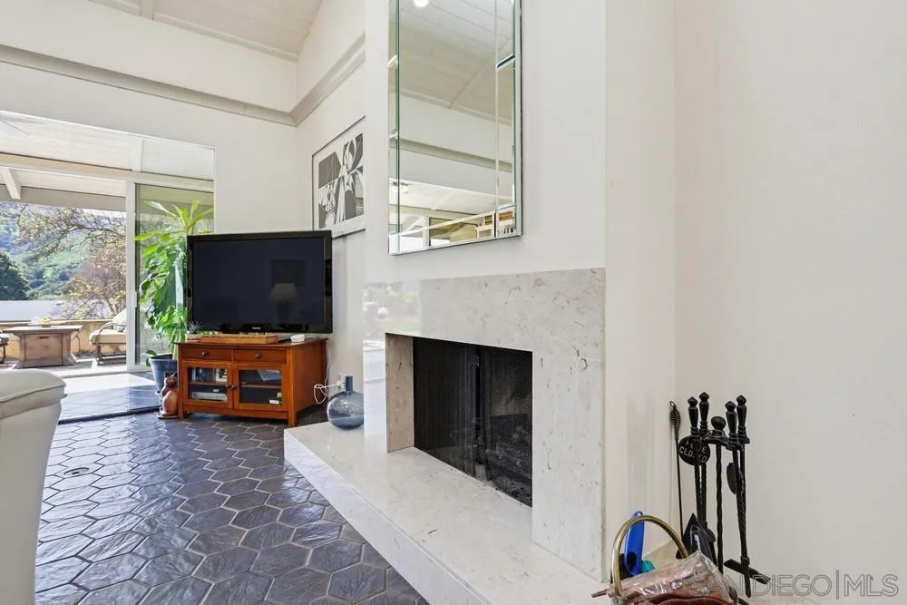 16057 El Tae Road, Unit 31 Pauma Valley, CA 92061 - Photo 8 of 25 a living room with furniture a flat screen tv and a fireplace