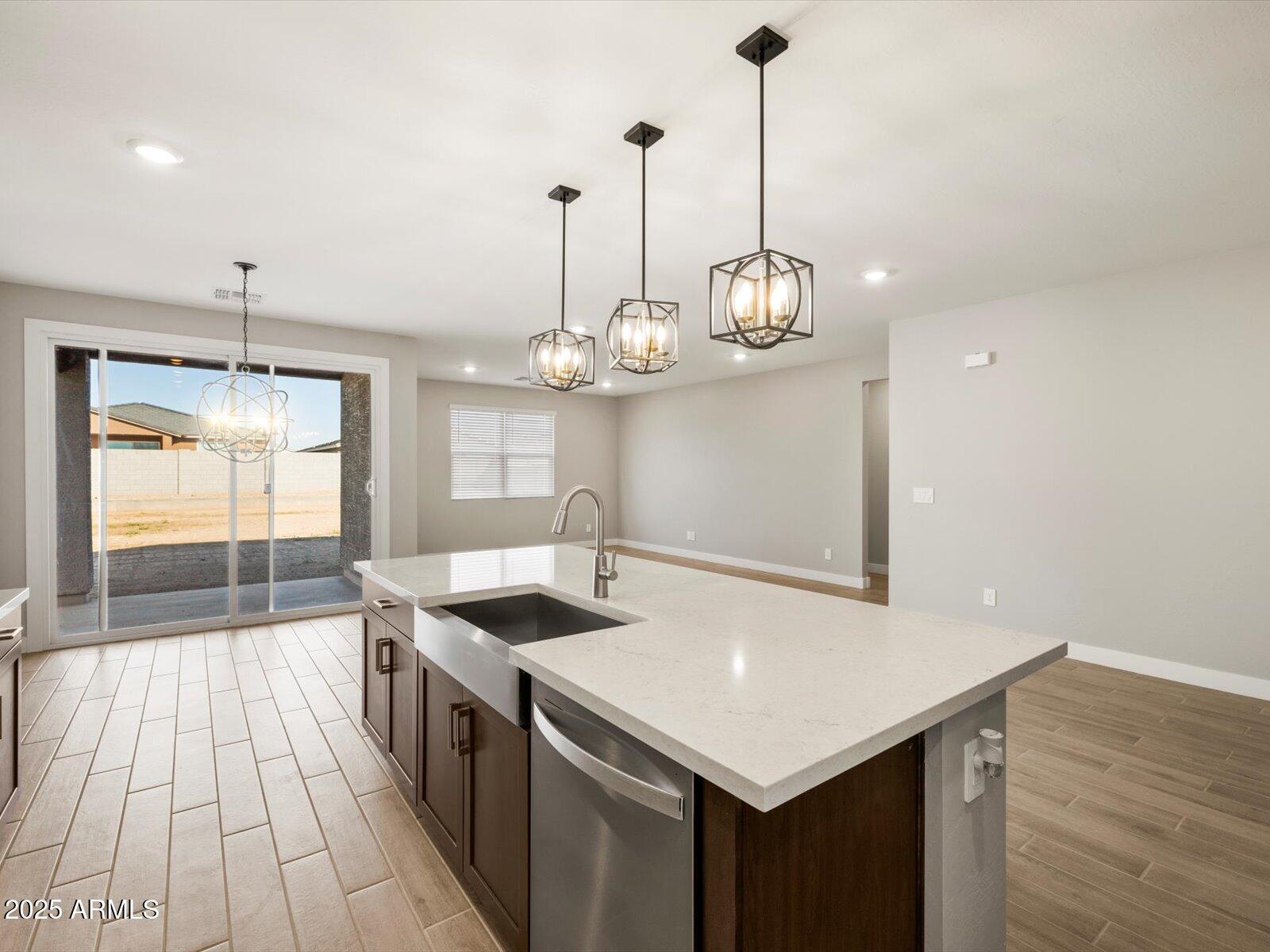 4818 North 178th Lane Goodyear, AZ 85395 - Photo 7 of 38 a kitchen that has a lot of cabinets and wooden floor