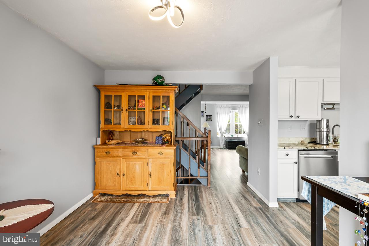8450 Stonewall Road Manassas, VA 20110 - Photo 13 of 48 a view of a kitchen with fridge and wooden floor