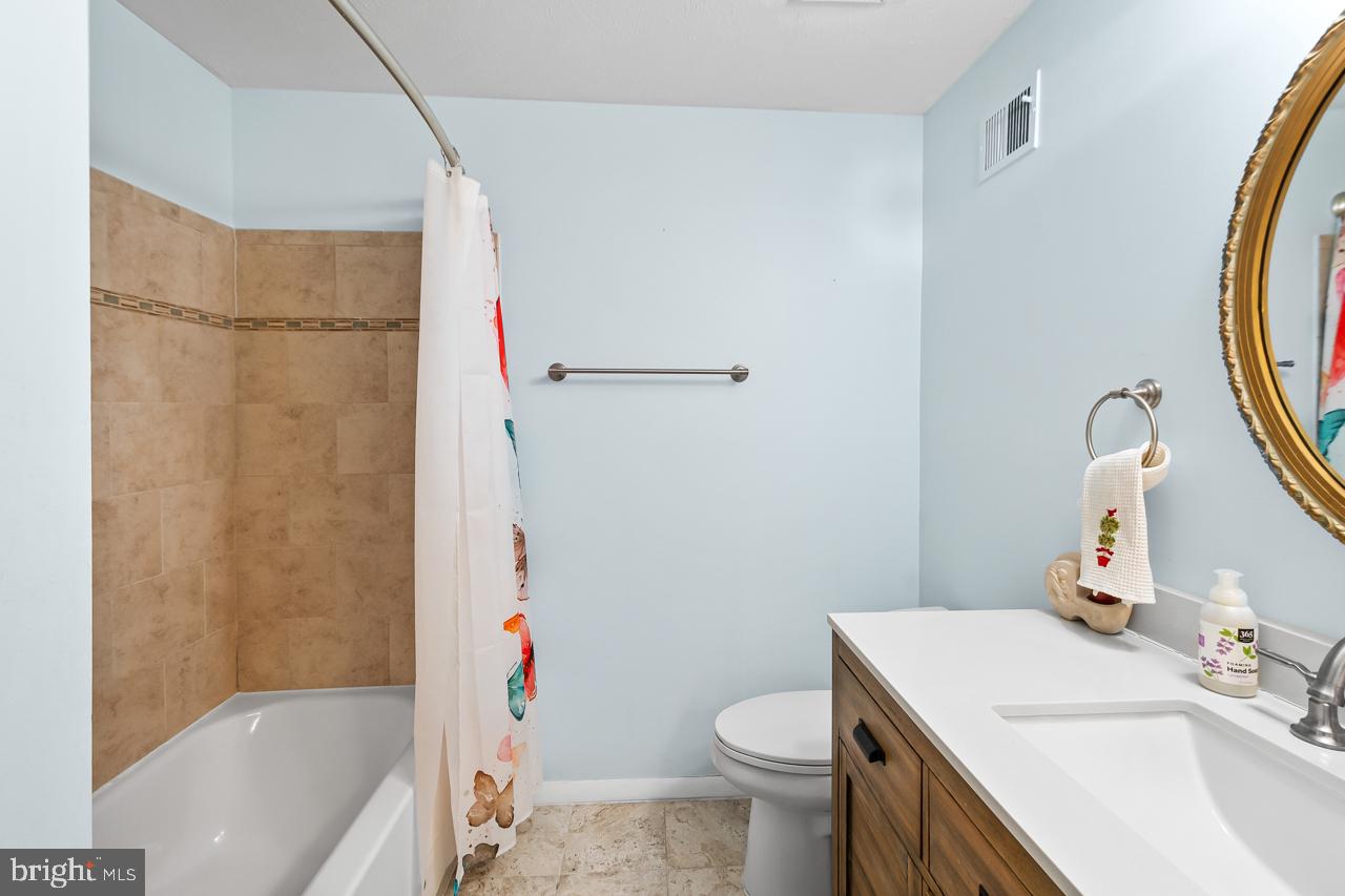8450 Stonewall Road Manassas, VA 20110 - Photo 22 of 48 a bathroom with a sink toilet vanity and shower