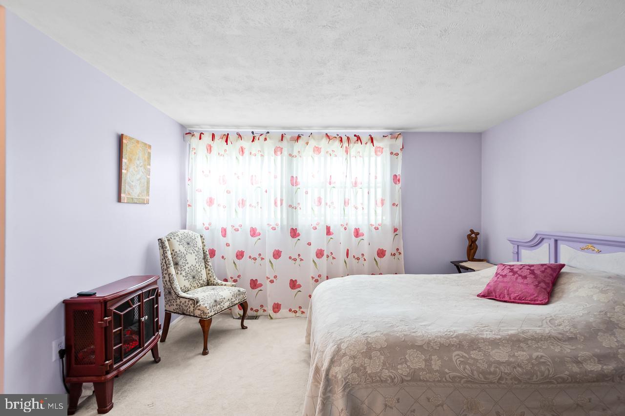 8450 Stonewall Road Manassas, VA 20110 - Photo 23 of 48 a bedroom with a bed and a chair