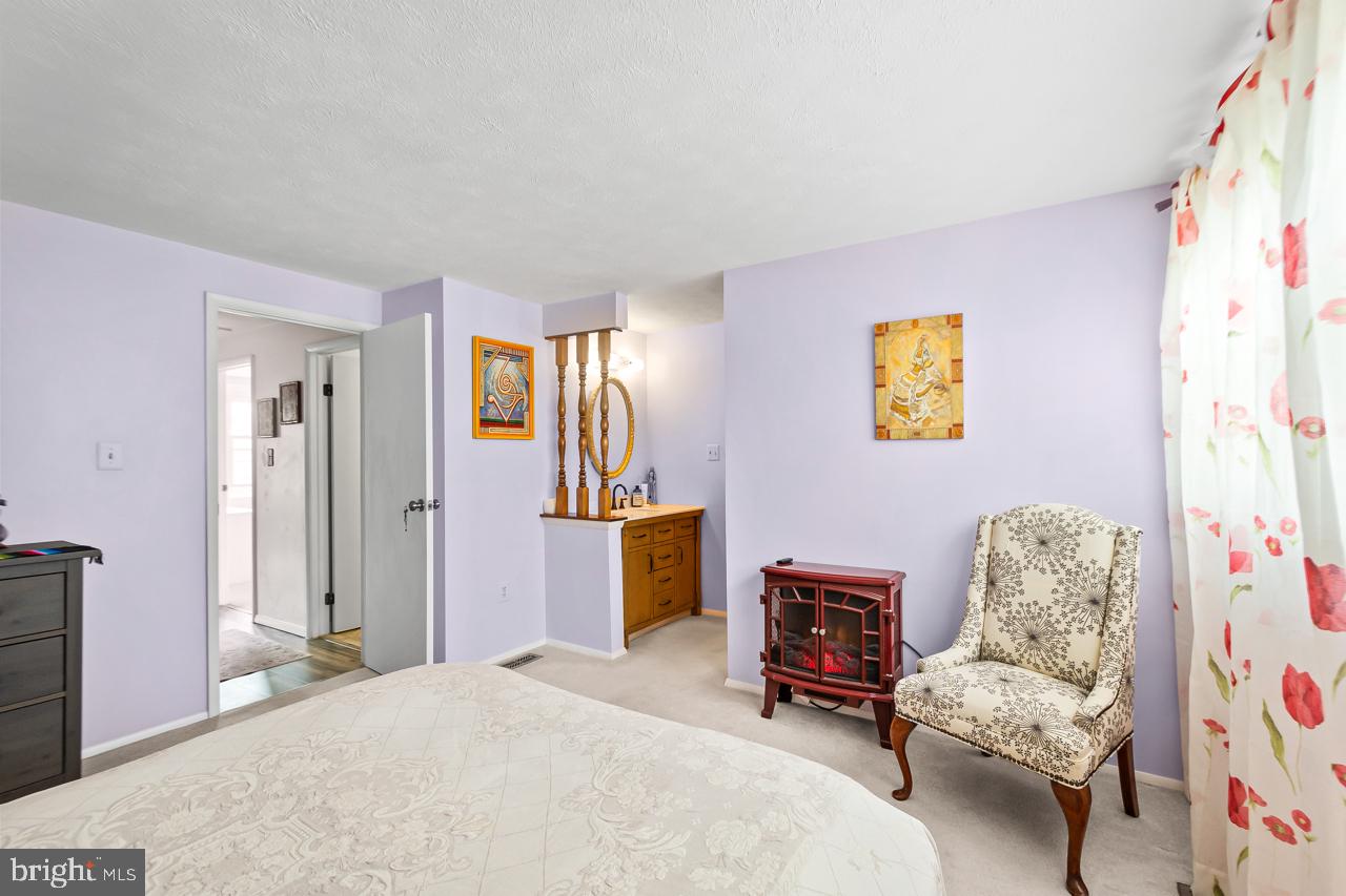 8450 Stonewall Road Manassas, VA 20110 - Photo 25 of 48 a bedroom with a bed and a couch
