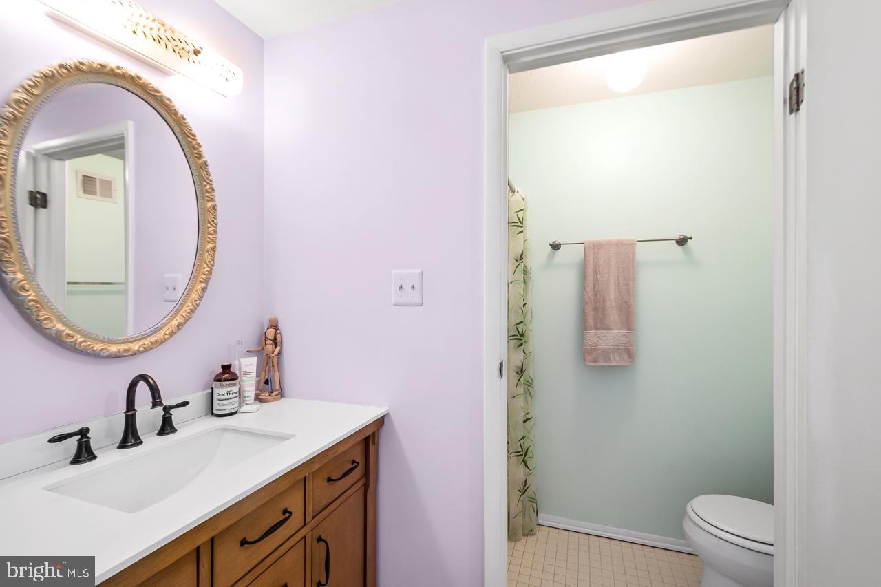8450 Stonewall Road Manassas, VA 20110 - Photo 26 of 48 a bathroom with a granite countertop sink mirror vanity and toilet