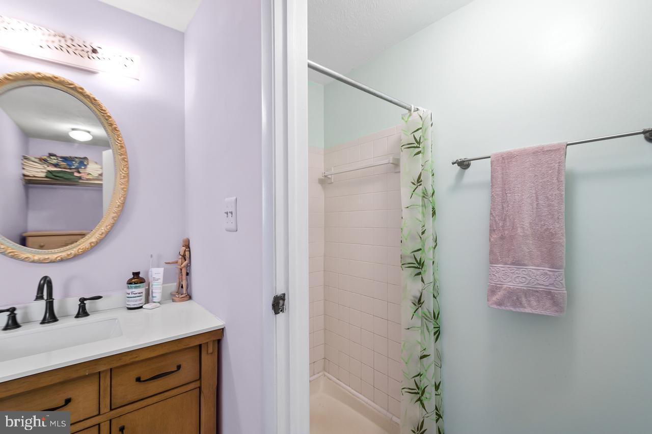 8450 Stonewall Road Manassas, VA 20110 - Photo 27 of 48 a bathroom with a sink vanity granite and a mirror