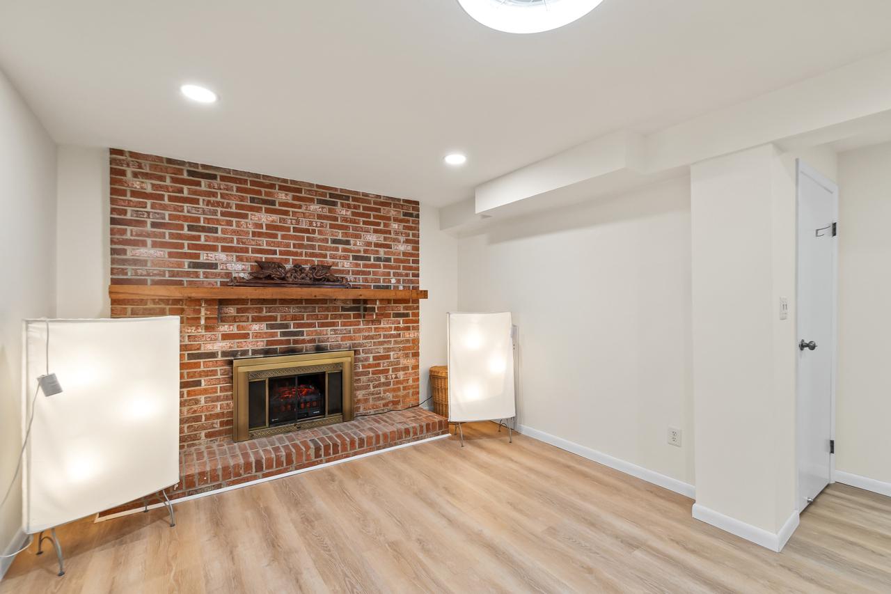 8450 Stonewall Road Manassas, VA 20110 - Photo 29 of 48 a view of empty room with wooden floor and fireplace