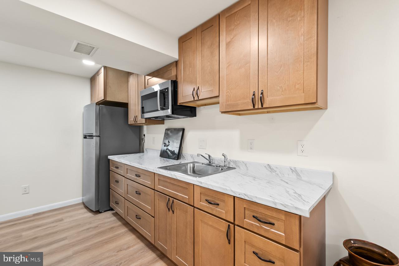 8450 Stonewall Road Manassas, VA 20110 - Photo 33 of 48 a kitchen with stainless steel appliances granite countertop a sink stove and cabinets