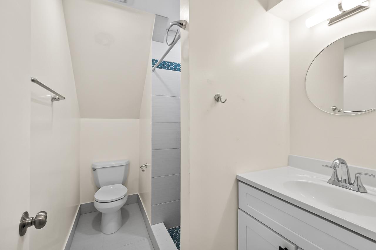 8450 Stonewall Road Manassas, VA 20110 - Photo 35 of 48 a bathroom with a granite countertop sink toilet and shower