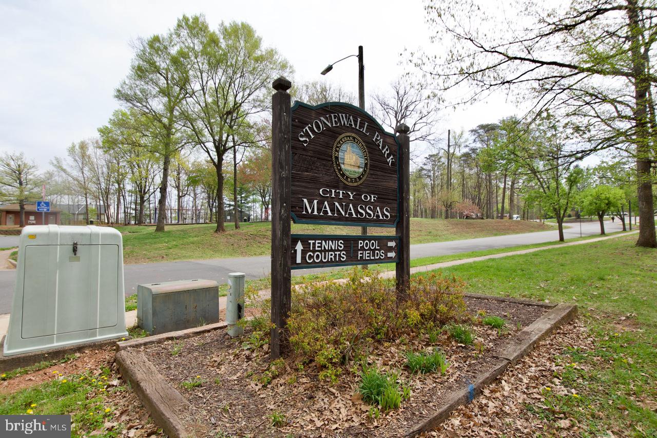 8450 Stonewall Road Manassas, VA 20110 - Photo 39 of 48 a view of a street sign under a large tree