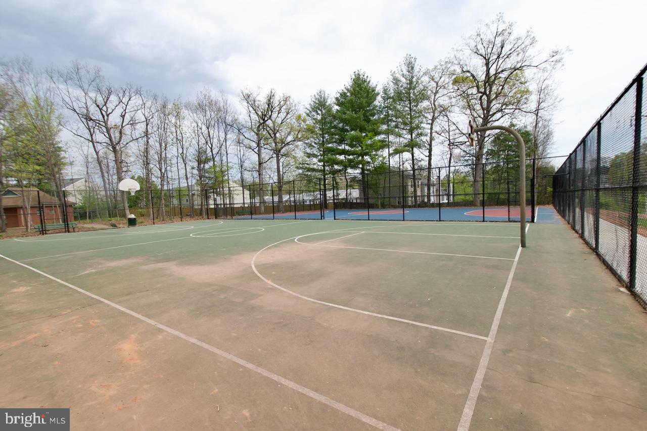 8450 Stonewall Road Manassas, VA 20110 - Photo 42 of 48 a view of a tennis ground with large trees