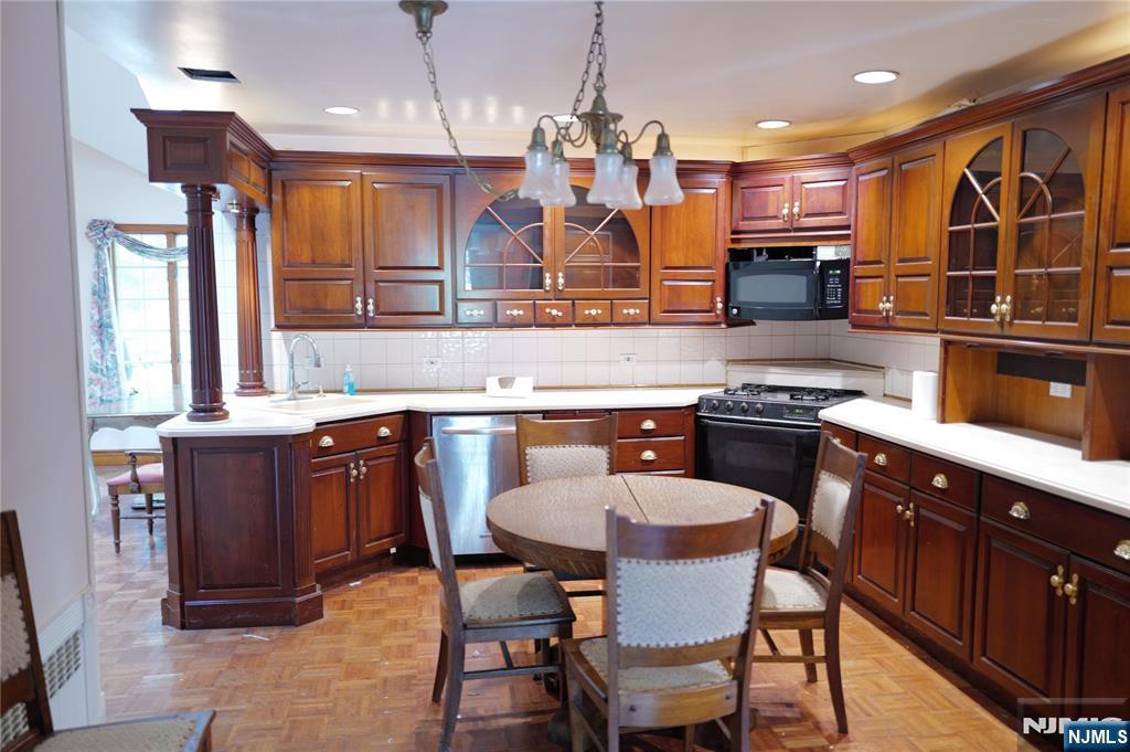 106 Prescott Street Demarest, NJ 07627 - Photo 2 of 24 a kitchen with a table chairs sink and cabinets