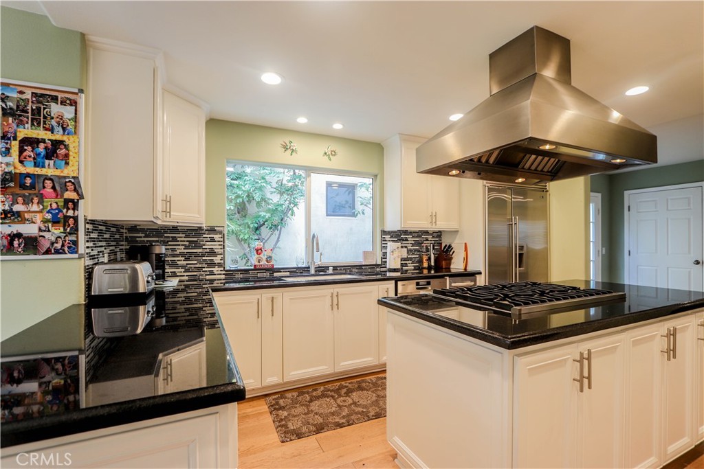 5 Cambridge Manhattan Beach, CA 90266 - Photo 26 of 71 a kitchen with stainless steel appliances granite countertop a sink a stove and a refrigerator