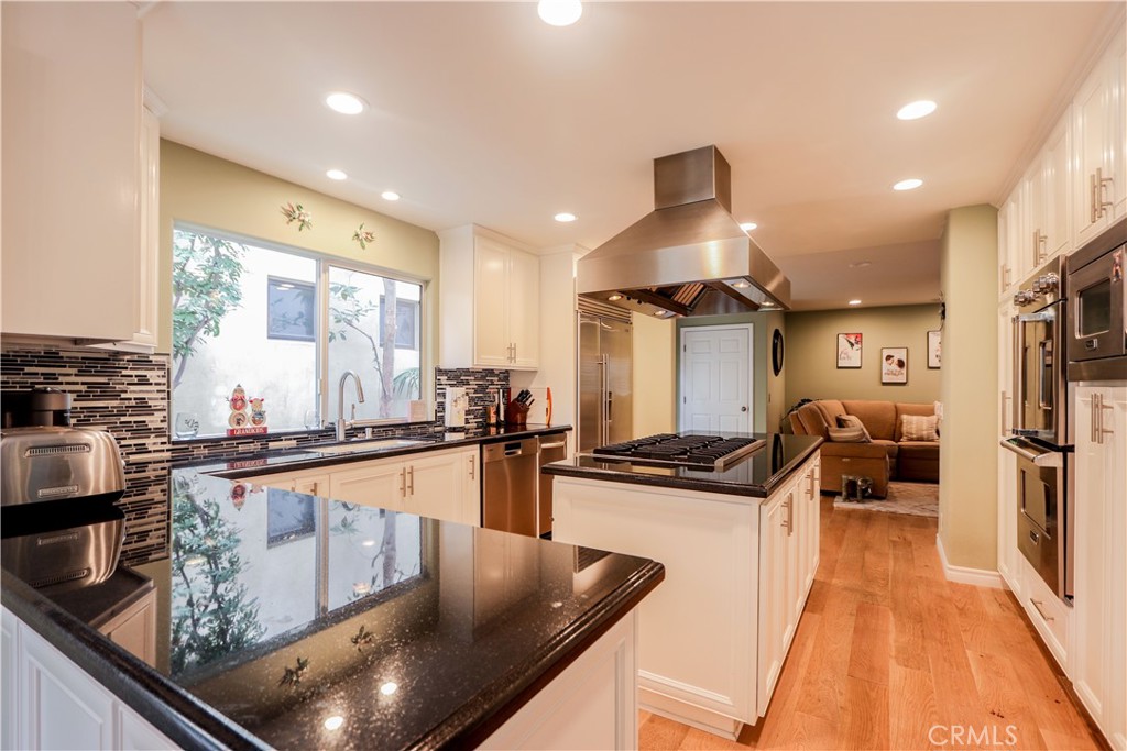 5 Cambridge Manhattan Beach, CA 90266 - Photo 29 of 71 a kitchen with stainless steel appliances granite countertop a sink stove and refrigerator