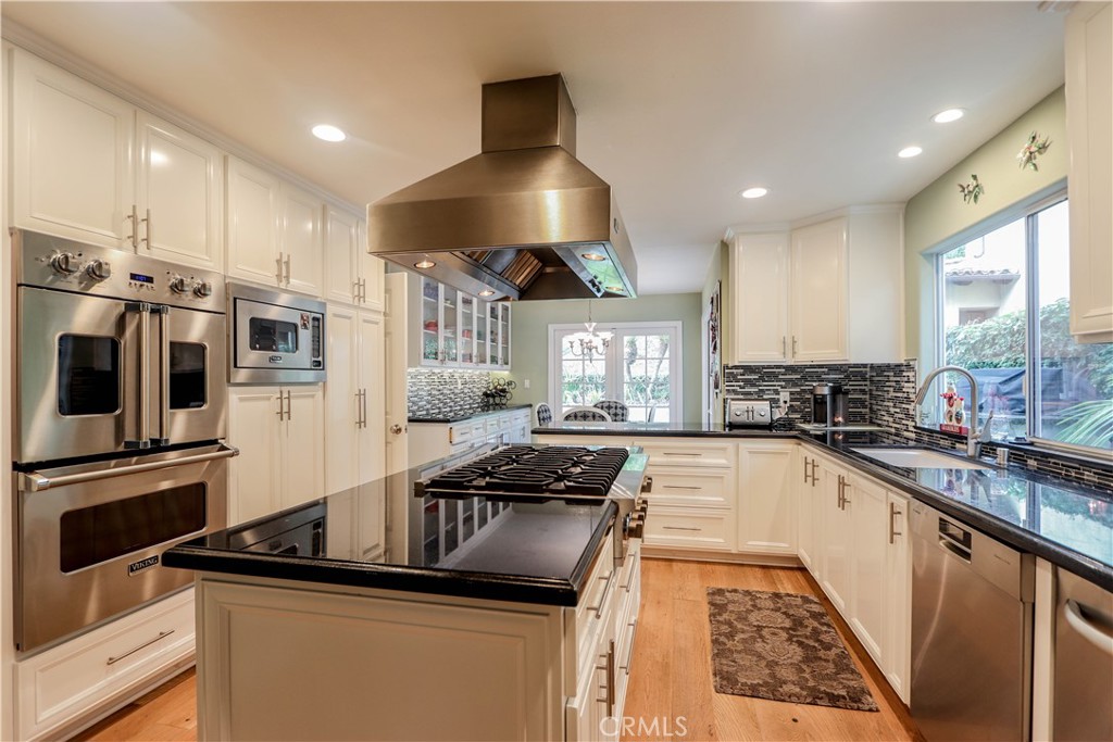 5 Cambridge Manhattan Beach, CA 90266 - Photo 31 of 71 a kitchen with granite countertop a sink stainless steel appliances and cabinets