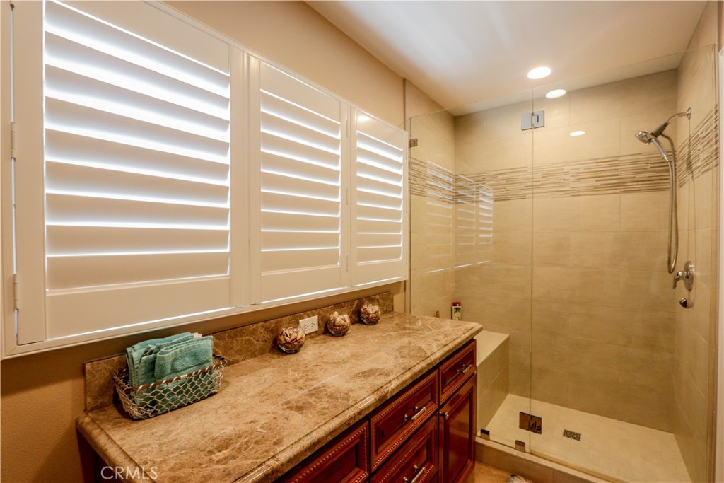 5 Cambridge Manhattan Beach, CA 90266 - Photo 34 of 71 a bathroom with a granite countertop sink and a mirror