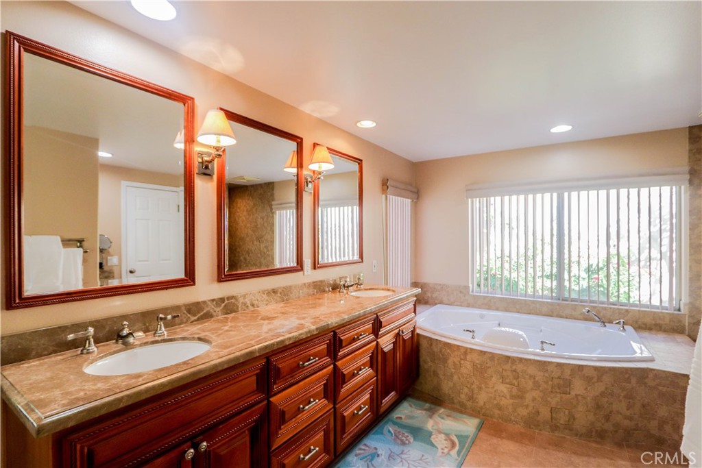 5 Cambridge Manhattan Beach, CA 90266 - Photo 40 of 71 a spacious bathroom with a granite countertop tub sink and mirror