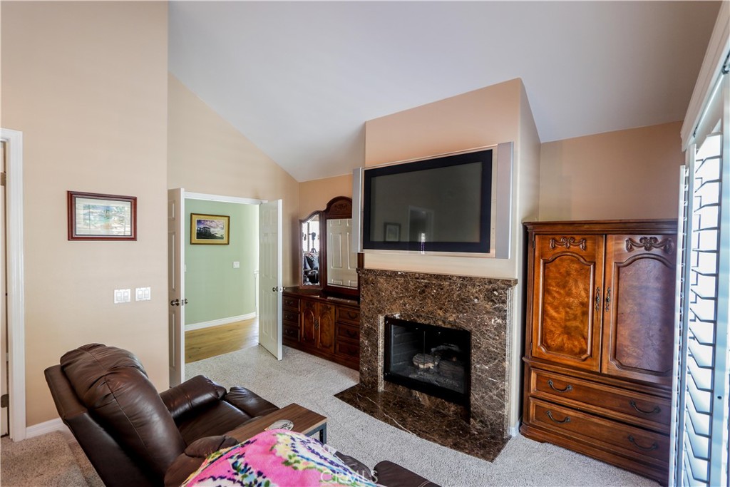 5 Cambridge Manhattan Beach, CA 90266 - Photo 49 of 71 a living room with furniture a flat screen tv and a fireplace