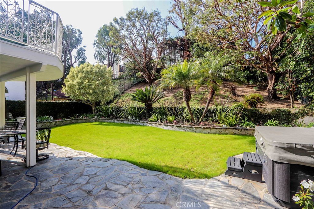 5 Cambridge Manhattan Beach, CA 90266 - Photo 60 of 71 a view of a swimming pool with lawn chairs under an umbrella