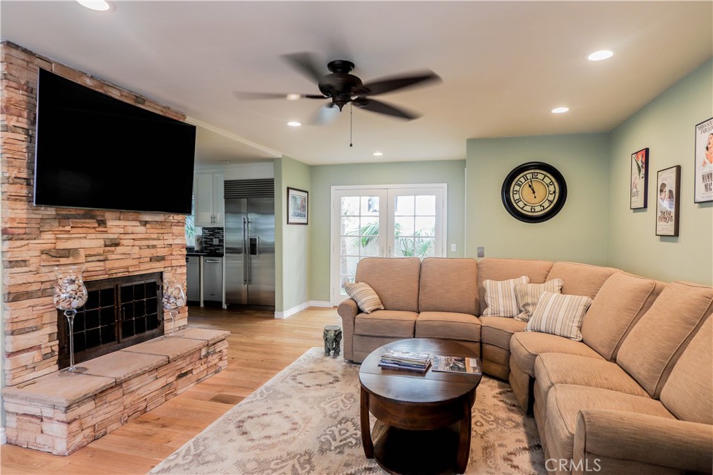 5 Cambridge Manhattan Beach, CA 90266 - Photo 62 of 71 a living room with furniture a fireplace and a flat screen tv