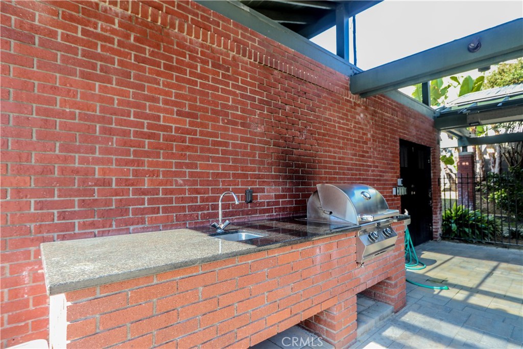 5 Cambridge Manhattan Beach, CA 90266 - Photo 69 of 71 a kitchen with granite countertop stainless steel appliances a sink and a counter