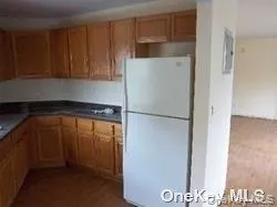 a kitchen with a refrigerator and cabinets