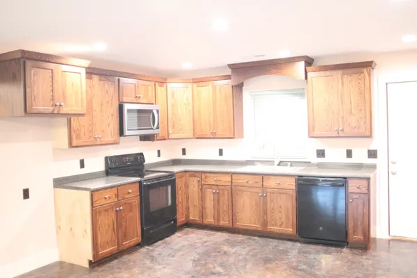 a kitchen with a sink stove and cabinets