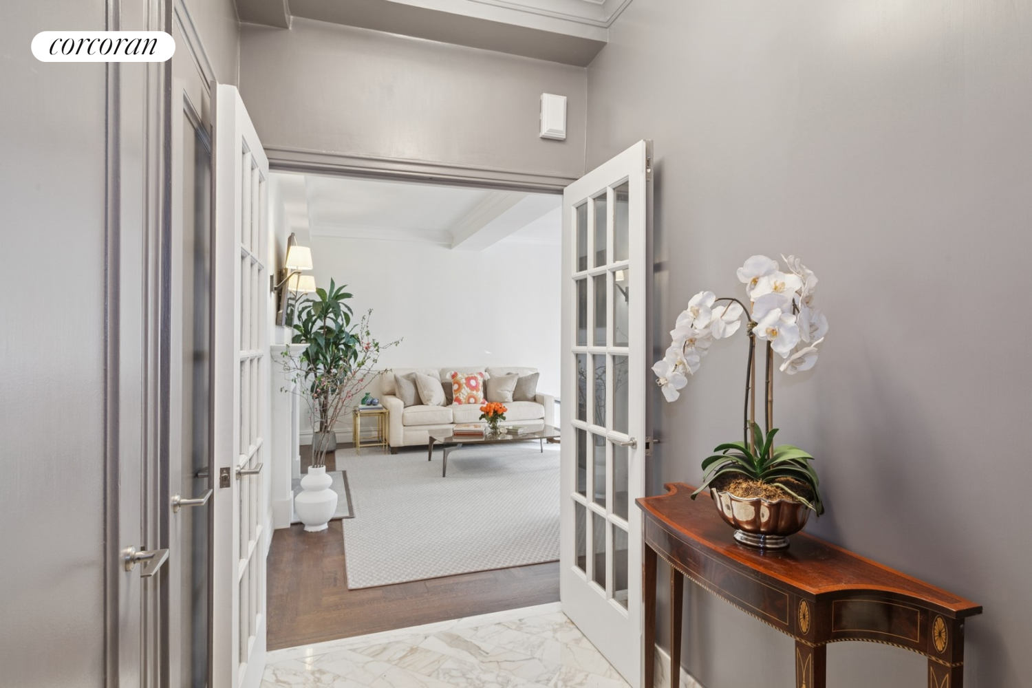 a living room with furniture and flowers