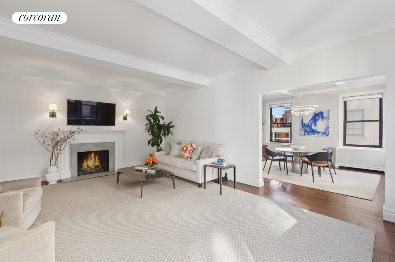 55 East 72nd Street, Unit 11N Manhattan, NY 10021 - Photo 2 of 14 a living room with furniture a fireplace and a flat screen tv