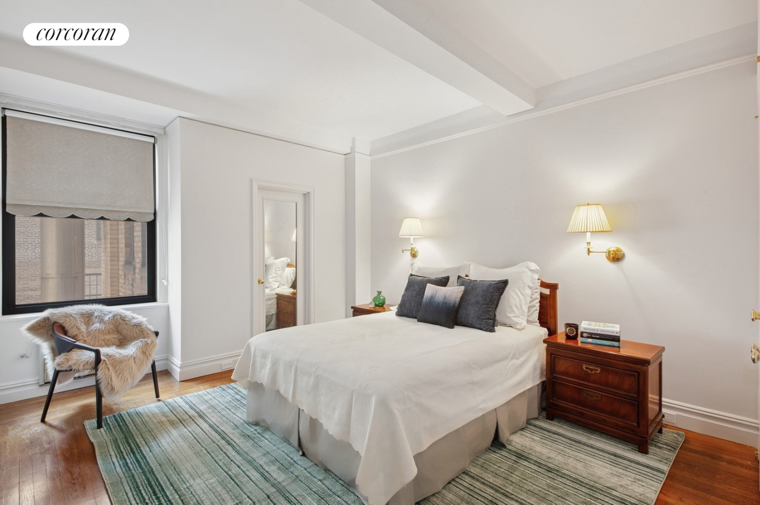 55 East 72nd Street, Unit 11N Manhattan, NY 10021 - Photo 7 of 14 a bedroom with a bed and wooden floor