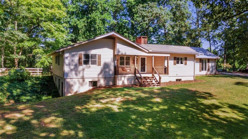 574 Lickskillet Road Epworth, GA 30541 - Photo 1 of 1 a front view of a house with a garden