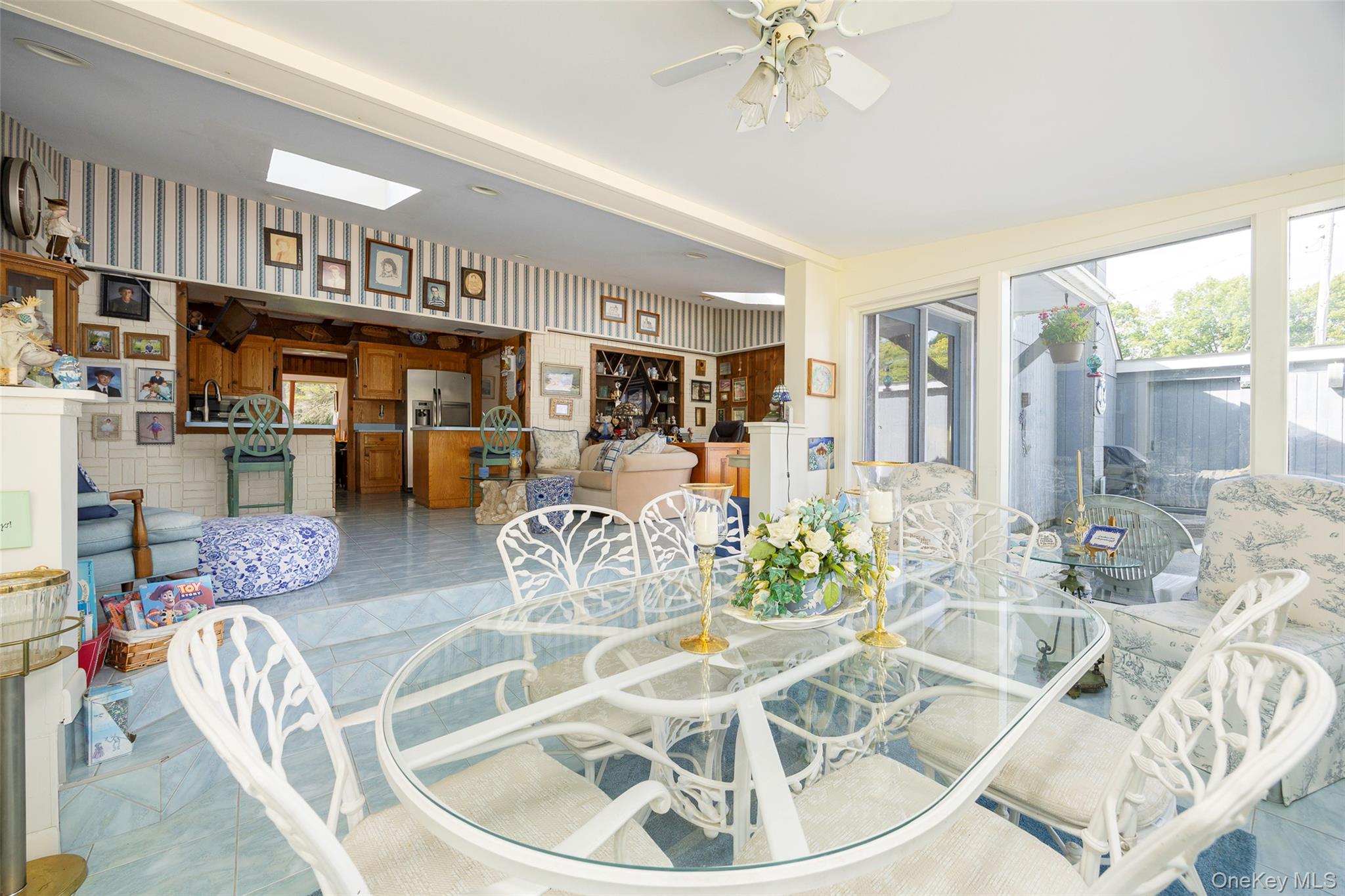 89 Deer Pond Road Verbank, NY 12585 - Photo 13 of 40 a living room with furniture a chandelier and a floor to ceiling window