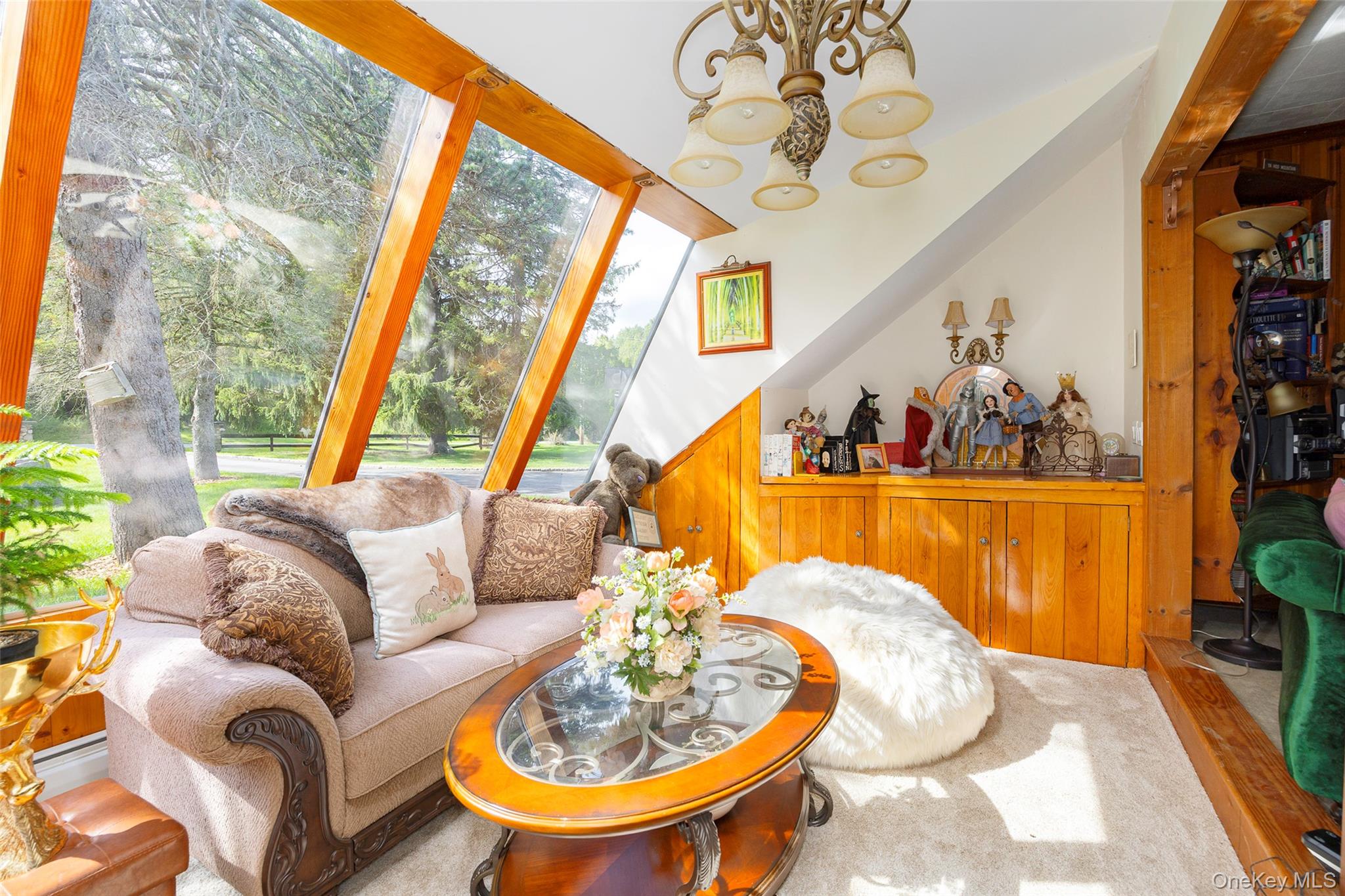 89 Deer Pond Road Verbank, NY 12585 - Photo 19 of 40 a living room with furniture and a chandelier