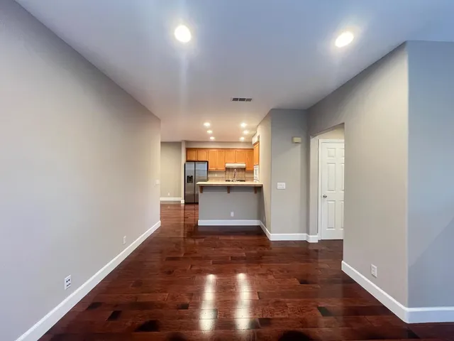en empty room with windows and ceiling fan
