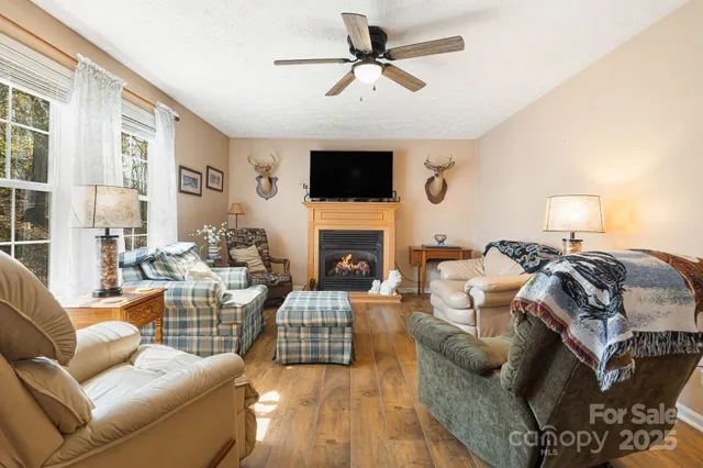a living room with furniture a flat screen tv and a fireplace