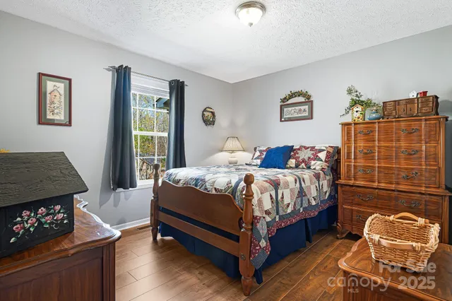 a bedroom with a bed chair and a window