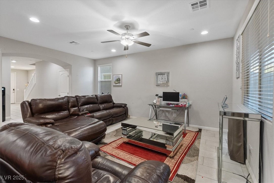 936 Keesey Way Henderson, NV 89052 - Photo 11 of 30 Living area with recessed lighting, light tile patterned floors, arched walkways, ceiling fan, and a desk