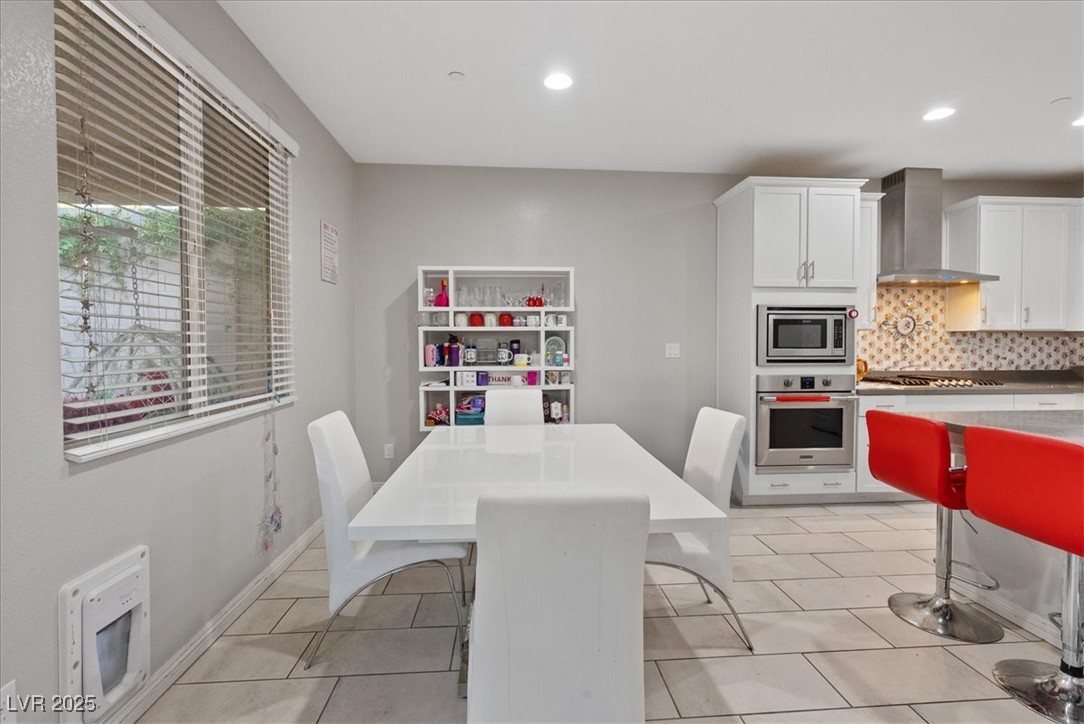 936 Keesey Way Henderson, NV 89052 - Photo 14 of 30 Dining area featuring light tile patterned flooring, heating unit, and recessed lighting